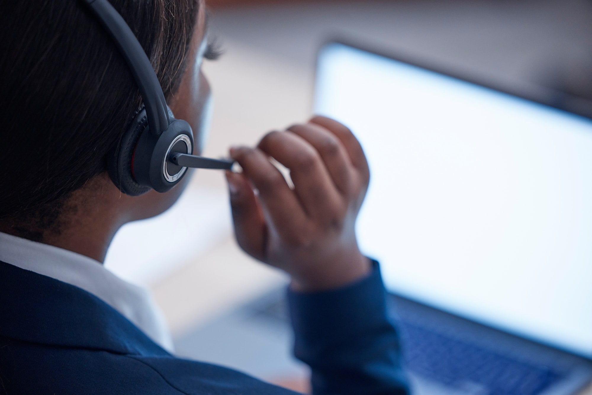 Woman, call center and laptop in night with microphone, talk and tech support in office at help des